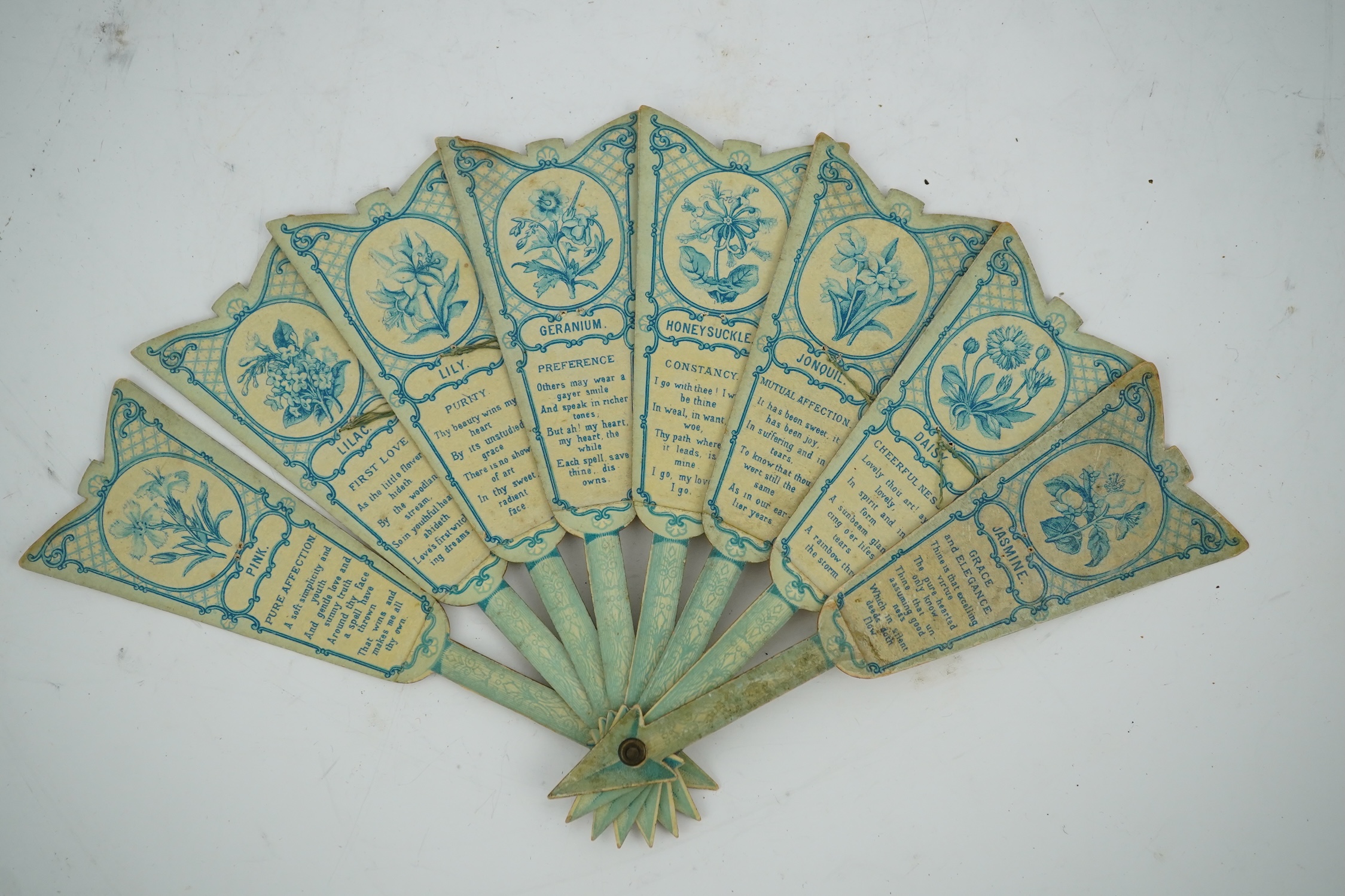 Three novelty fans with a mixed Brussels lace fan and black lace fan, a small language of love in flowers fan, a paper windmill advertising French Café fan, a carved cream Bakelite fan, a black and gilt, lace and sequin